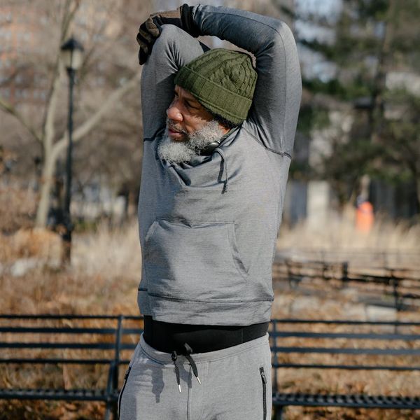 A man stretching outdoors, symbolizing vitality and well-being.