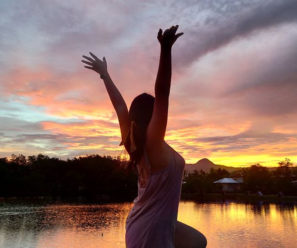 Silhouette of a person in a meditative pose against a calm background.
